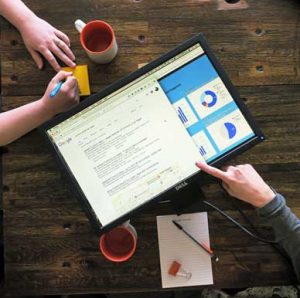 hands using a dell monitor as an ipad