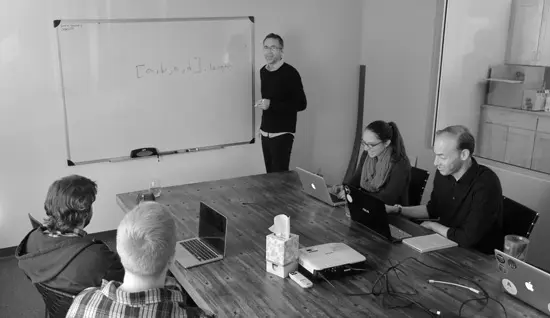 grey scale nico presenting to team