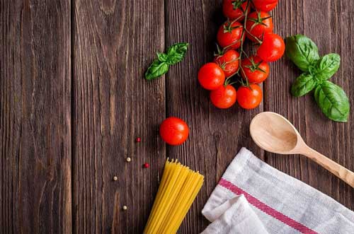 pasta, tomatoes and basil being prepared to cook