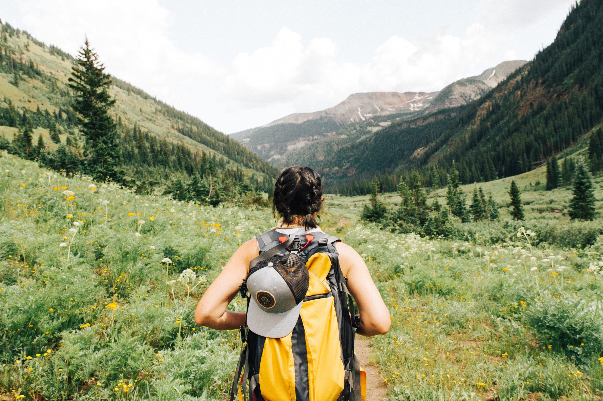 Woman hiking with outdoor gear.